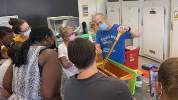 A Barnard educator shows teachers science-related contraption